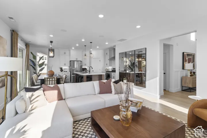 Open-concept living area with white walls and recessed lighting