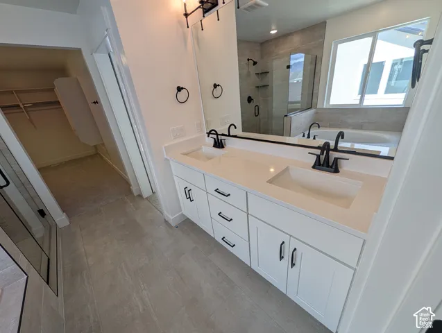 Double vanity with white cabinetry, matte black fixtures, and a large mirror
