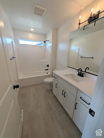 White vanity with a single basin sink and white countertop