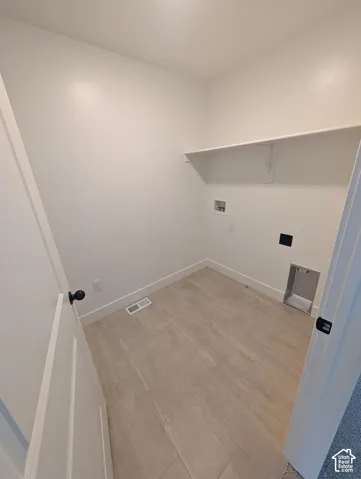 White interior walls, tile flooring, and an integrated shelf
