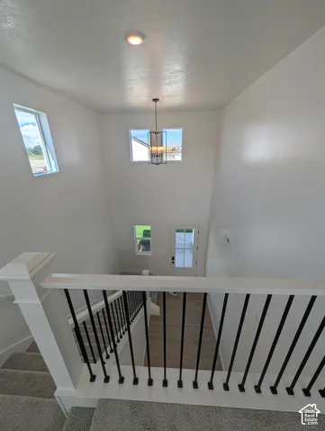 Two-story foyer with a vaulted ceiling, recessed lighting, and a contemporary chandelier