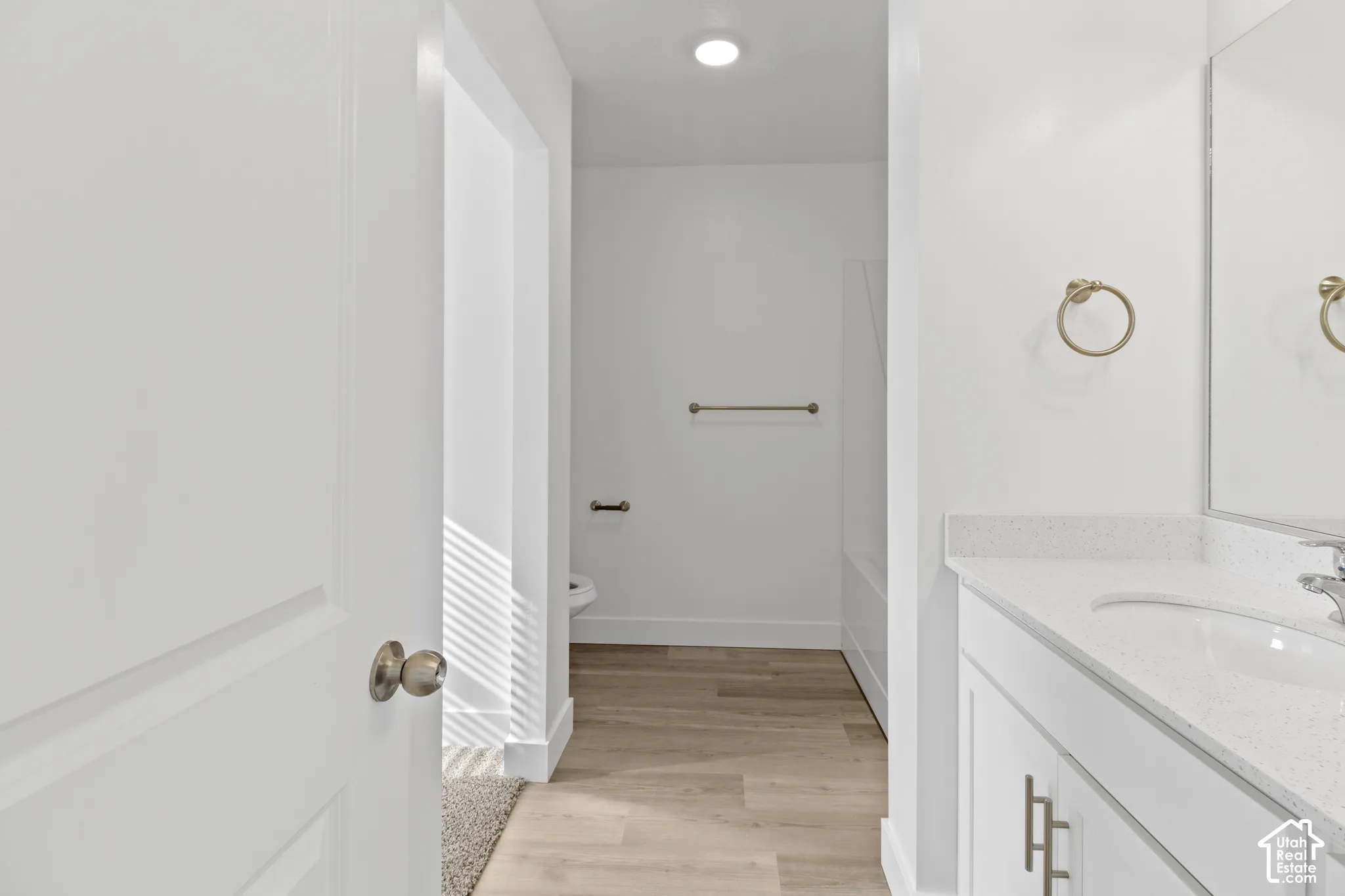 White vanity with an integrated sink and light-colored countertop