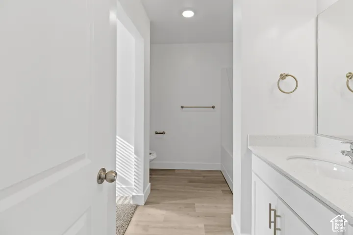 White vanity with an integrated sink and light-colored countertop