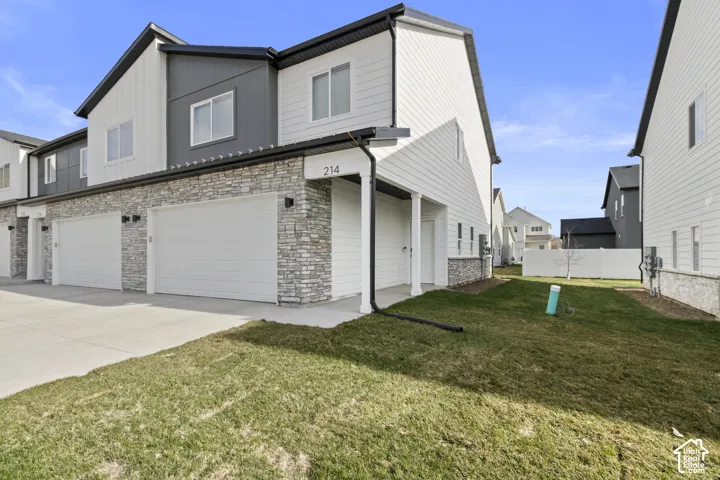Contemporary exterior with horizontal and vertical siding, stone accents, and a dual garage