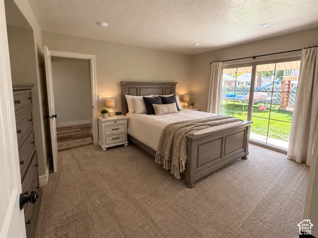 Master bedroom on main level. Carpeted flooring with recessed lighting and sliding glass doors. Brings in plenty of natural light