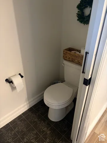 White toilet with patterned floor tile