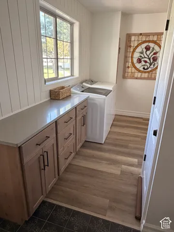 Light wood-finish flooring with a contrasting dark tile entry
