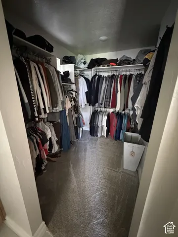 Master closet-Built-in shelving and hanging rods in a neutral color palette