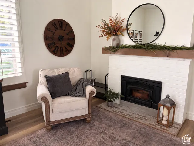 Brick fireplace with a wood mantel, black insert, and brick hearth