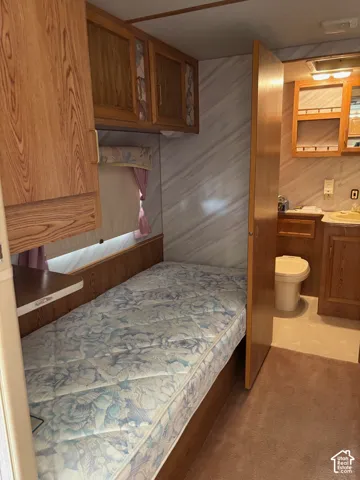 Built-in bed with storage cabinetry above