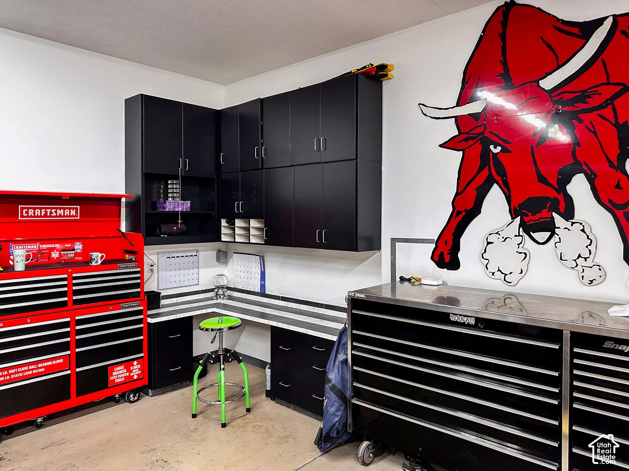 Built-in cabinetry providing extensive storage, corner workstation with durable countertop, and bright wall finishes