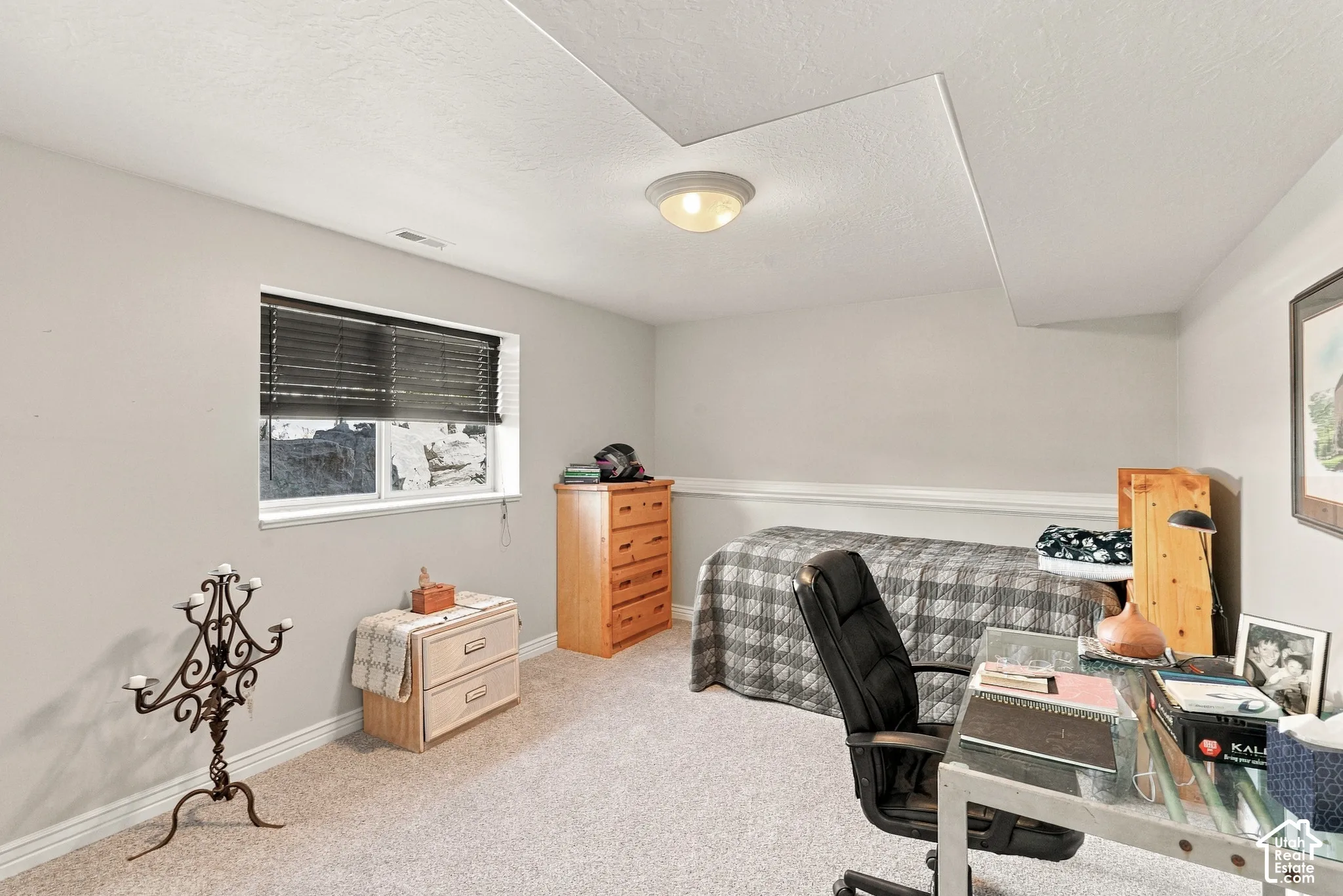 Carpeted floor, white walls, built-in window, overhead lighting, chair rail molding