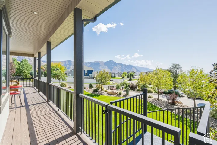 Covered porch with composite decking and dark railings