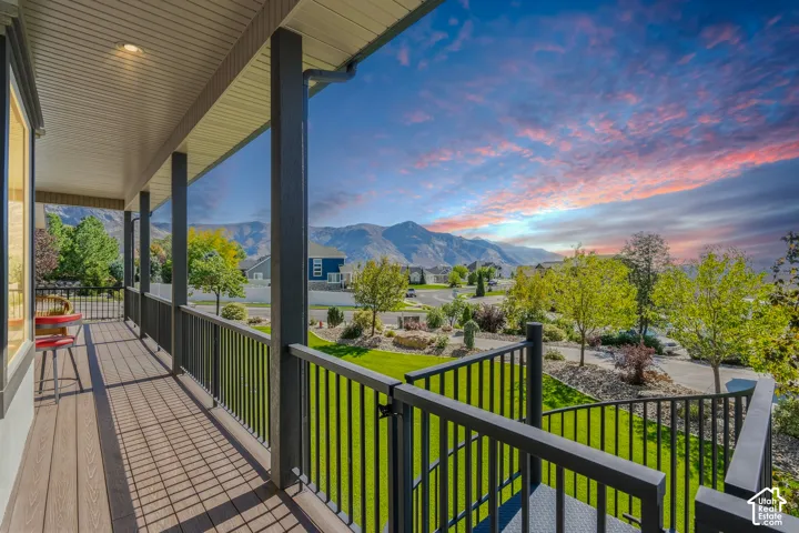 Covered porch with composite decking and dark railings