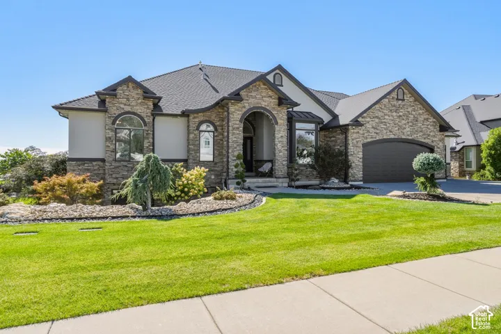 Striking stone and stucco exterior with arched entryways and multiple gables