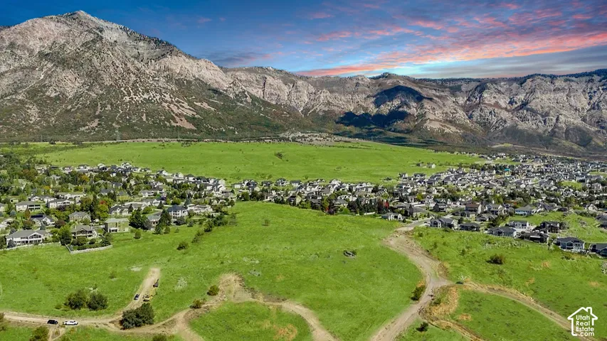 Expansive green landscapes with mountain backdrops and established residential areas