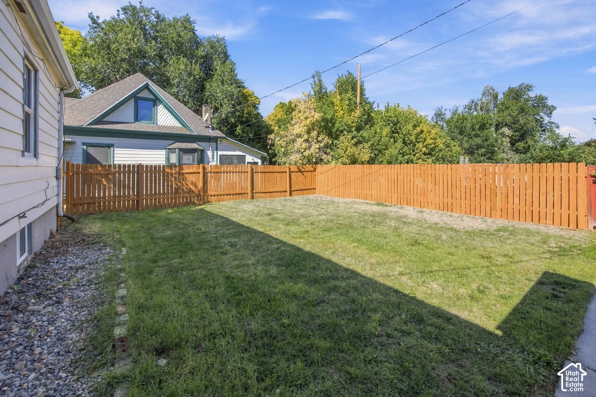 Expansive lawn area with a wood privacy fence
