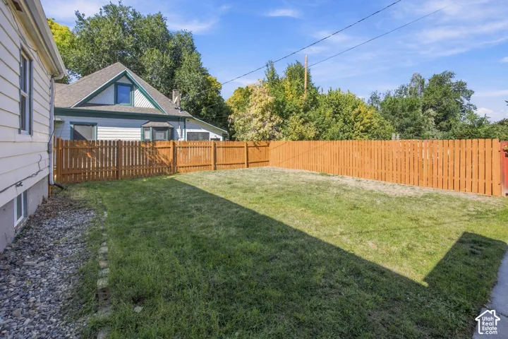 Expansive lawn area with a wood privacy fence