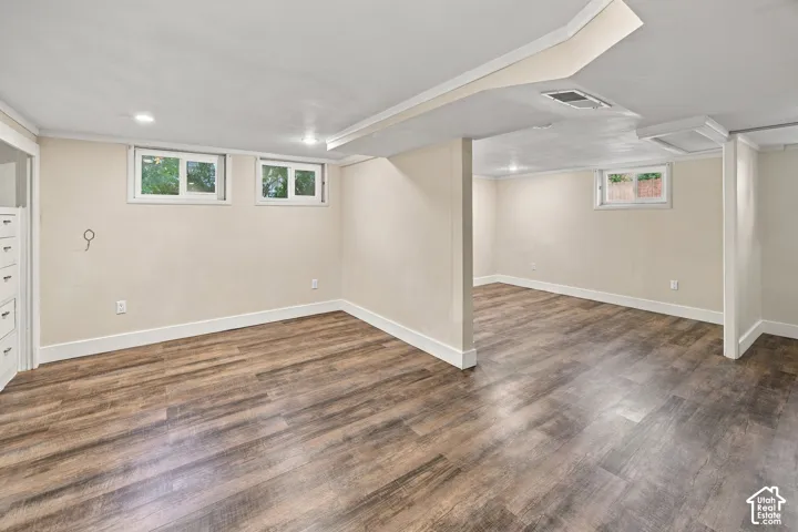Recessed lighting, wood-finish flooring, white trim, and built-in cabinetry