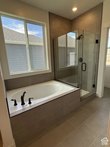 Primary Bathroom featuring soaker tub and walk in shower