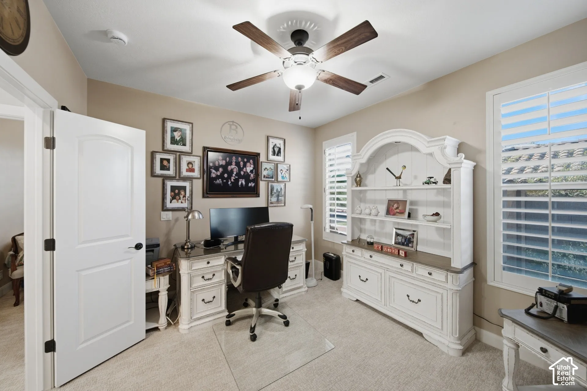 Recessed lighting with a ceiling fan, neutral wall tones, and plantation shutters