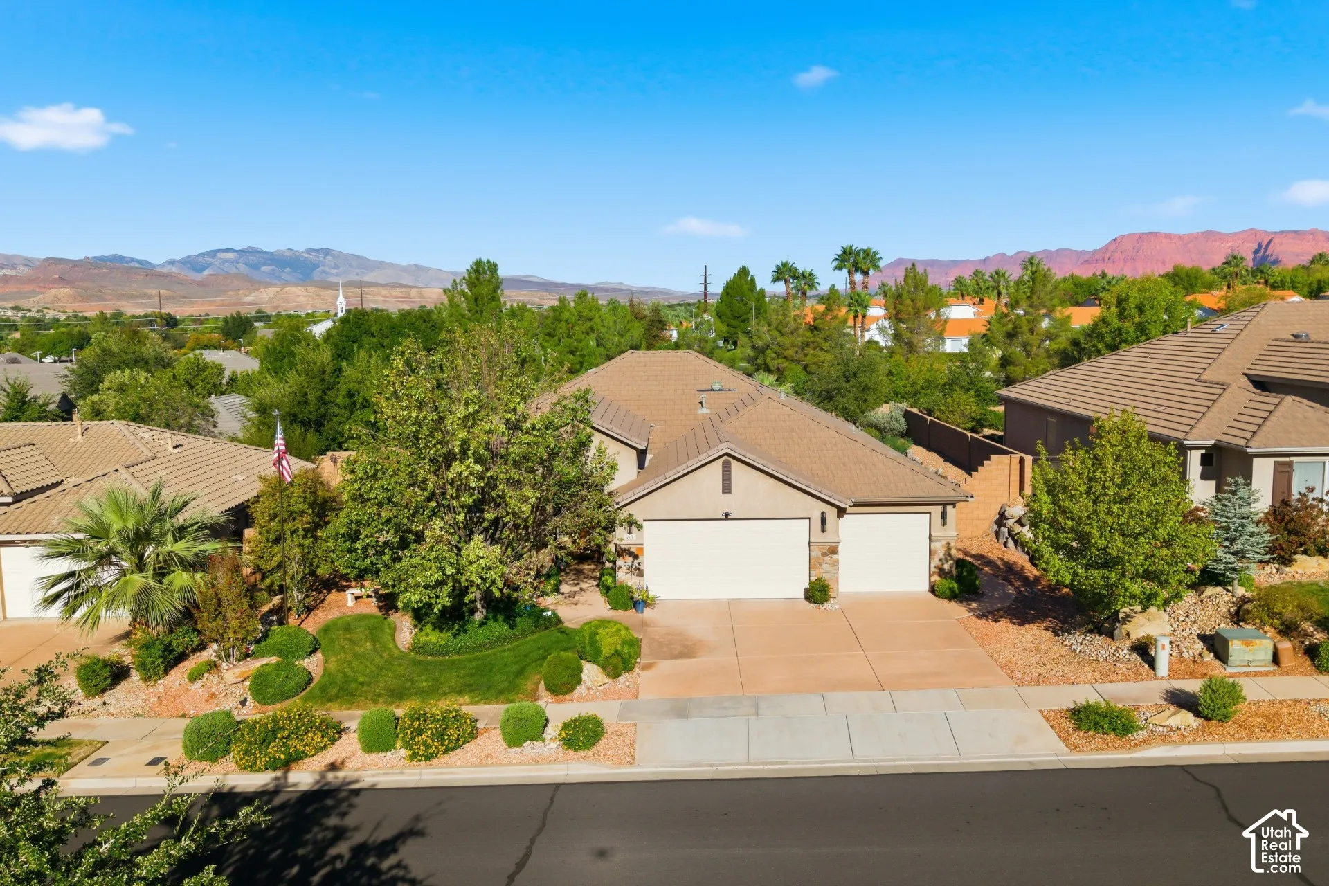 Neutral-toned exterior with a multi-car driveway and an attached two-car garage