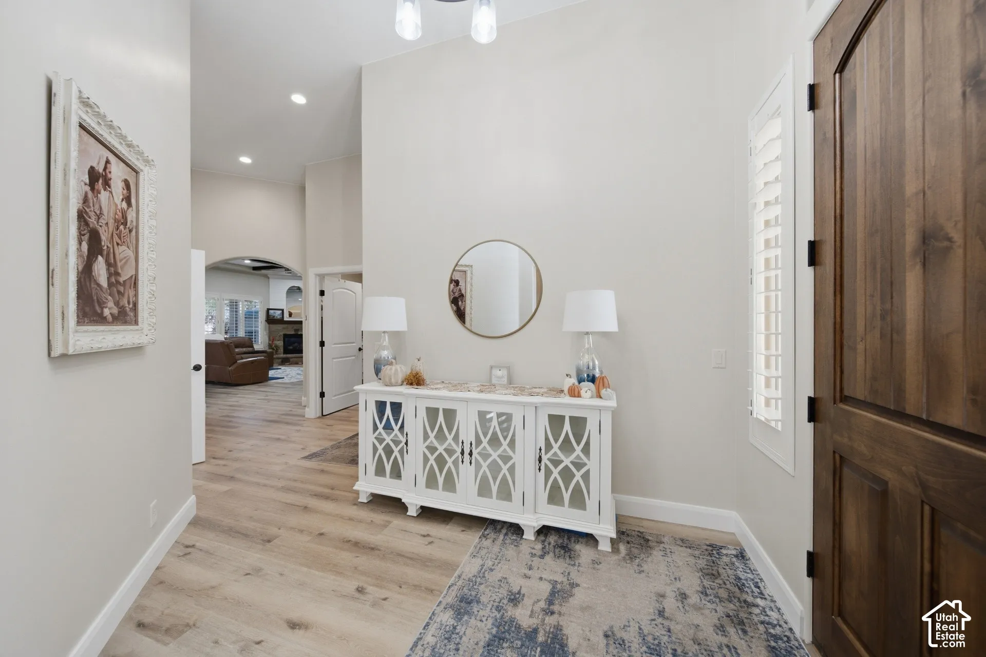Vaulted ceiling, recessed lighting, wood-finish flooring, plantation shutters, and a solid wood door