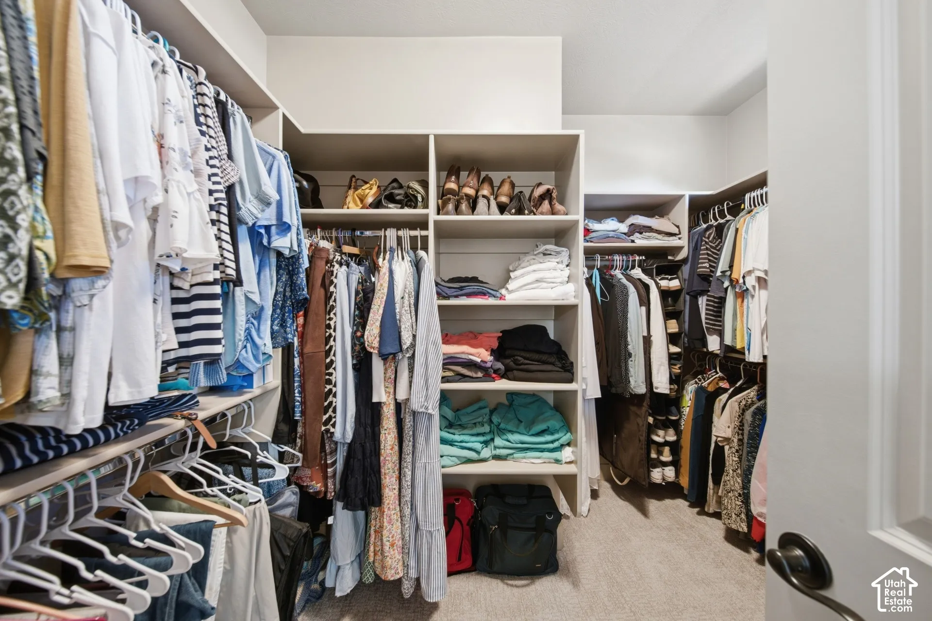 Custom built-in closet system with multiple shelving units and hanging rods