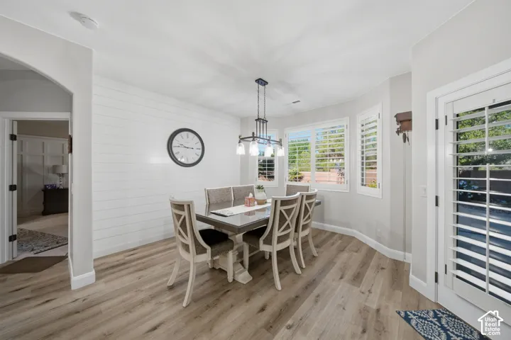 Wood-finish flooring throughout, complemented by a white shiplap accent wall