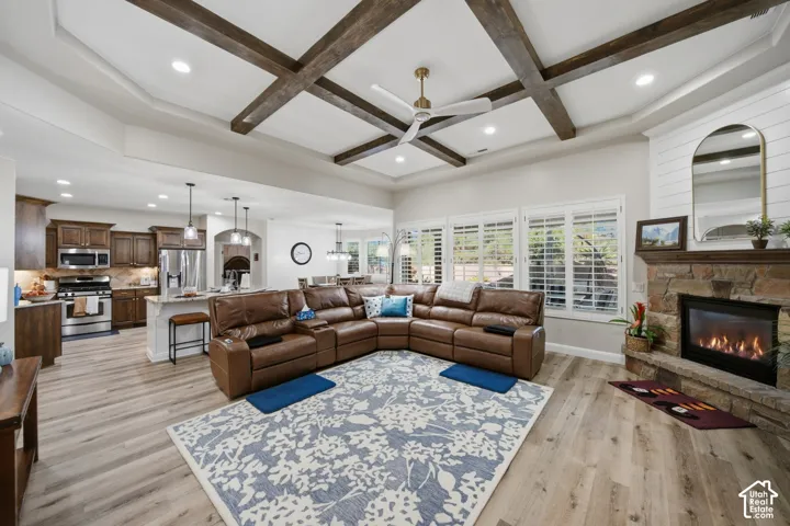 Tray ceiling with wood beam accents and recessed lighting