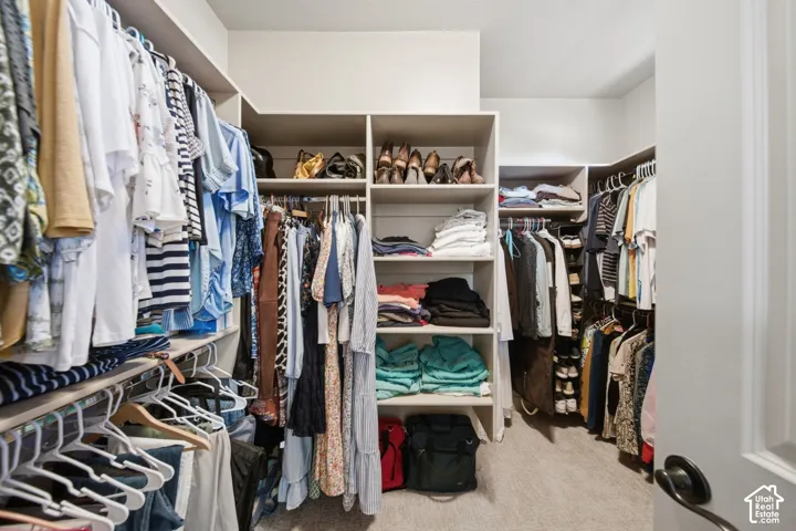 Custom built-in closet system with multiple shelving units and hanging rods