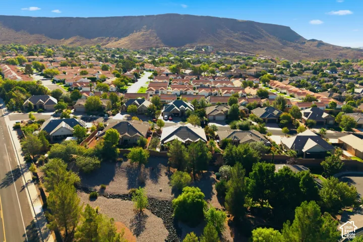 Residential neighborhood with consistent rooflines, established landscaping, and a distant mountain backdrop