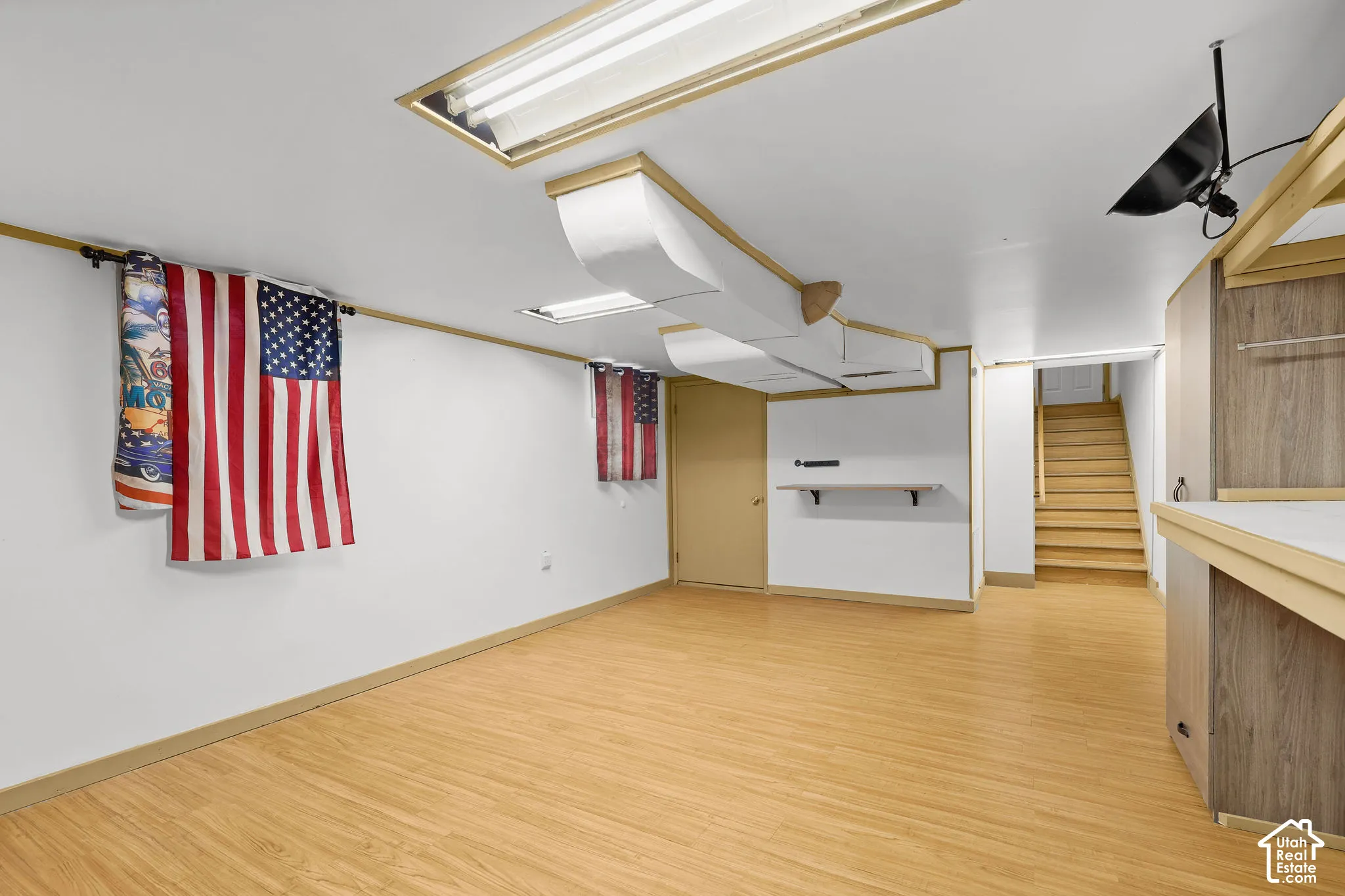 Wood-finish flooring with white walls and trim
