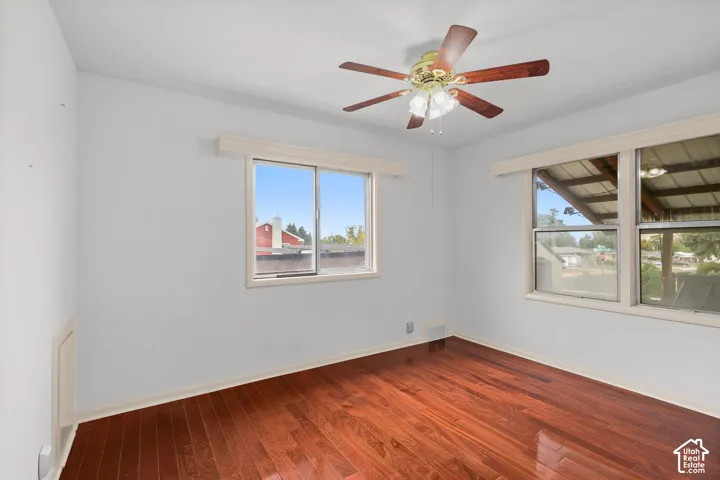 Hardwood-finish flooring with white walls and trim