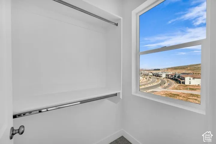 Built-in shelving with hanging rods and a window