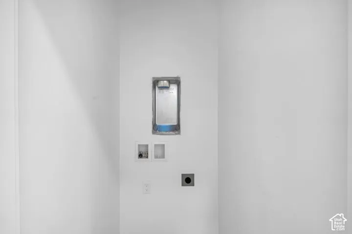 Dedicated laundry area featuring a recessed dryer vent, washer hookups, and electrical outlets