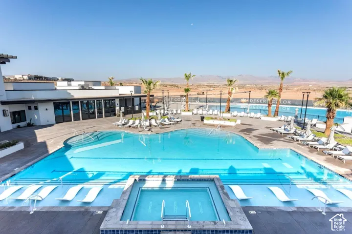 Expansive outdoor amenity area featuring multiple swimming pools, an integrated spa, and extensive lounging space