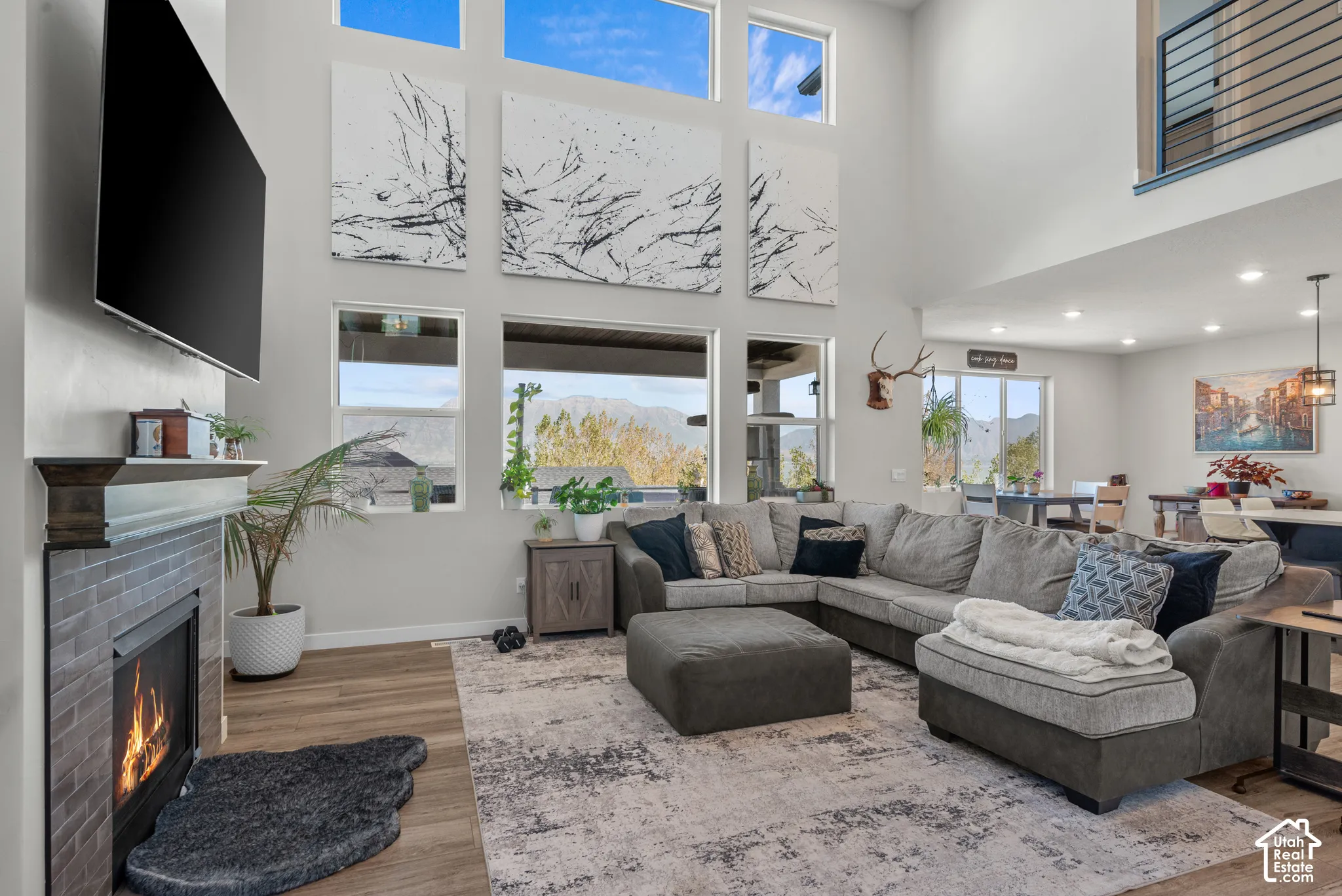 Expansive living area with tall ceilings, featuring a fireplace with a tile surround and a wood mantel