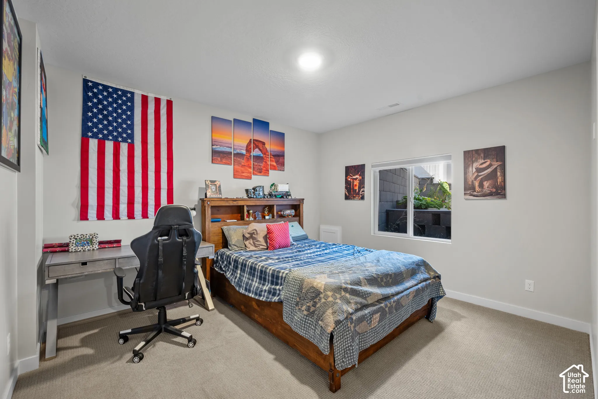 Neutral wall paint, carpet flooring, recessed ceiling light, and a window with exterior landscaping