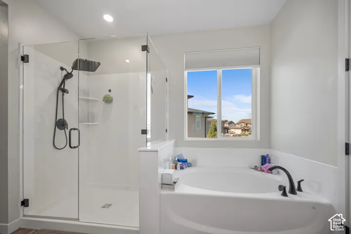Walk-in shower with clear glass enclosure and black fixtures