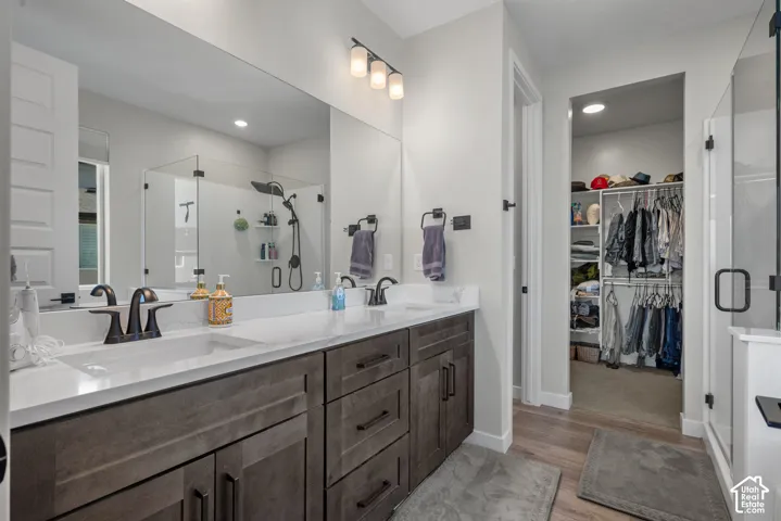 Dual vanity with dark wood-finish cabinetry and white countertops