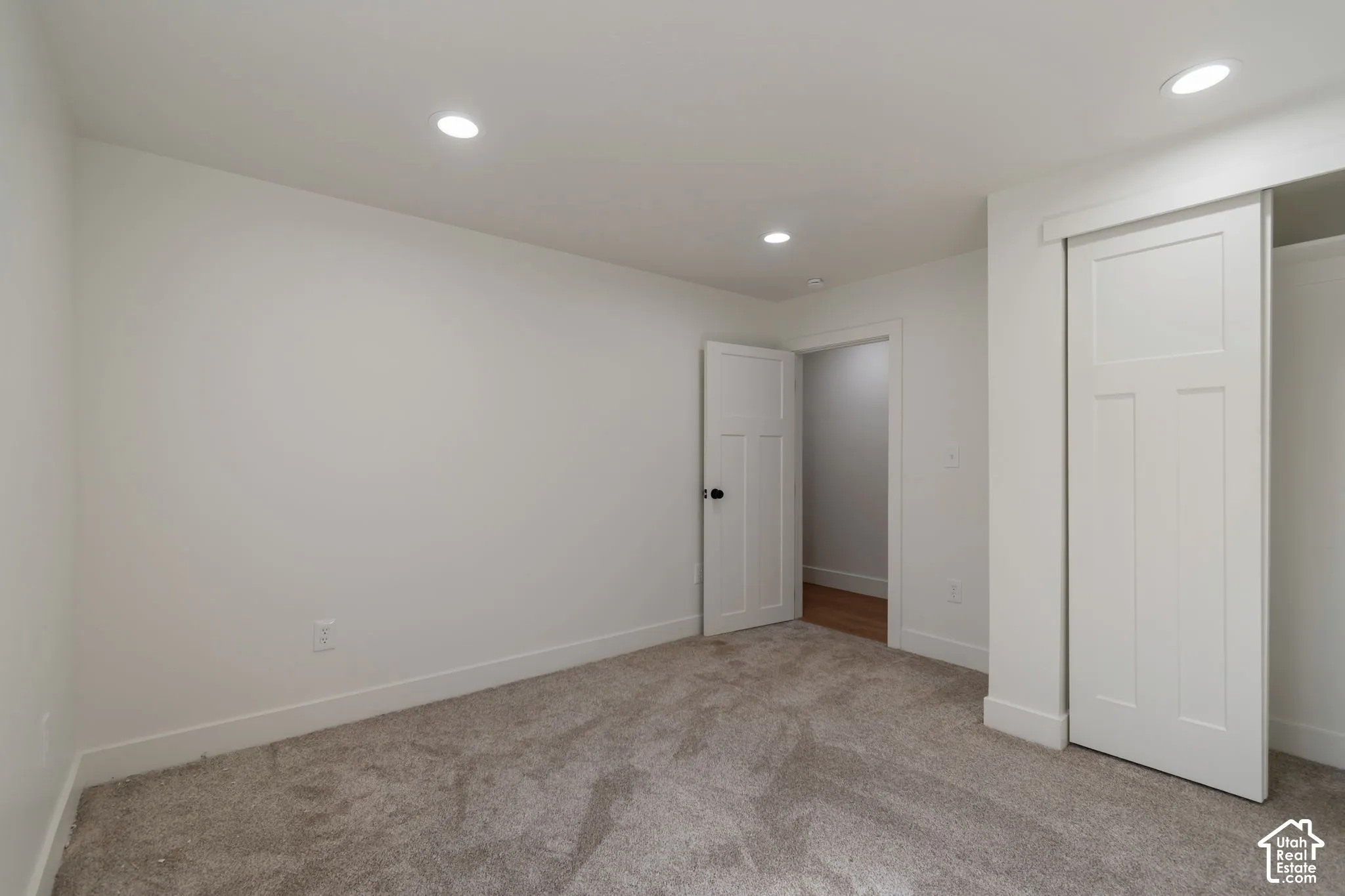 Neutral wall color, recessed lighting, carpet flooring, flat panel interior doors, and baseboard trim