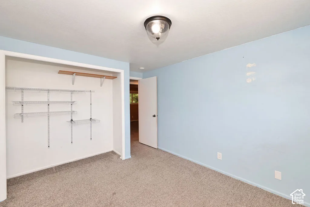 Recessed closet with adjustable wire shelving and a wood shelf