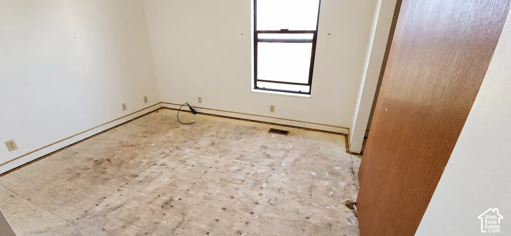 Window opening, wall-mounted outlets, wood-finish door, hard surface flooring