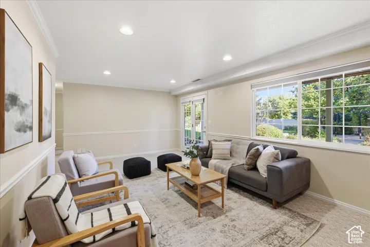 Interior space featuring recessed lighting, crown molding, chair rail detailing, a large picture window, and glass-paneled exterior doors