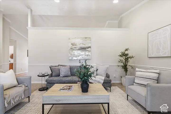 Vaulted ceiling, neutral wall color, and chair rail molding