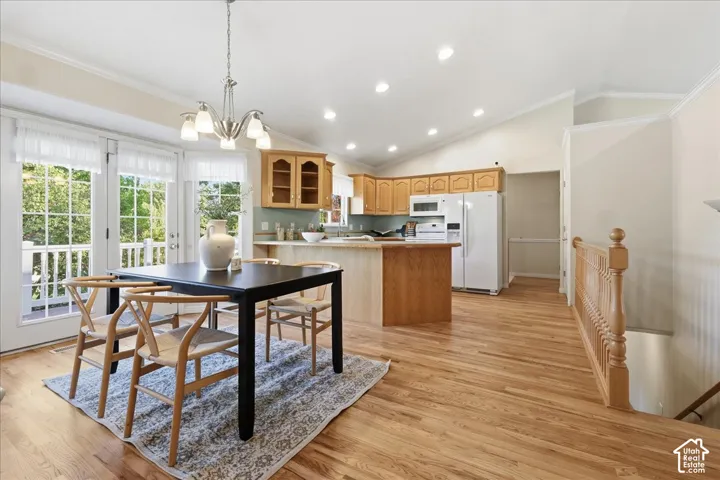 Kitchen featuring wood cabinetry, a peninsula, and recessed lighting, paired with wood-finish flooring and French doors