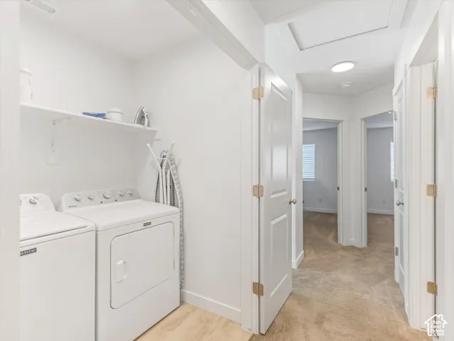 Laundry area with built-in shelving and wood-finish flooring