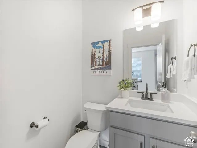 Vanity with a rectangular sink, light-toned countertop, and matte black faucet