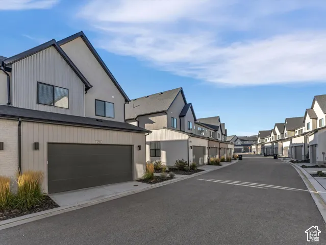 Modern exterior architecture with gabled roofs, vertical siding, and a two-car garage